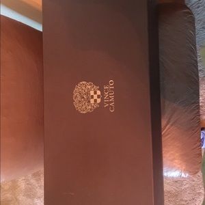 pair a of tan Vince Camuto gladiator boots